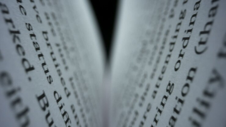 Closeup book sheets with english text. Camera moving between book pages