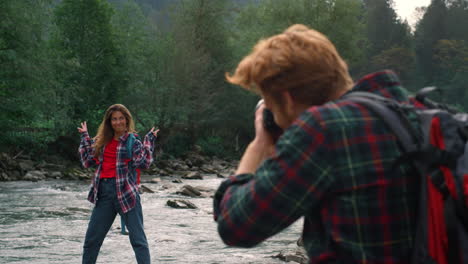 positive girl posing for male photographer. guy taking photos of female model