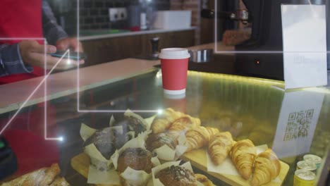 animación de puntos de luz sobre el hombre que sirve café trabajando en la cafetería.
