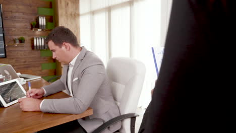 Following-shot-of-female-in-the-conference-room-with-charts