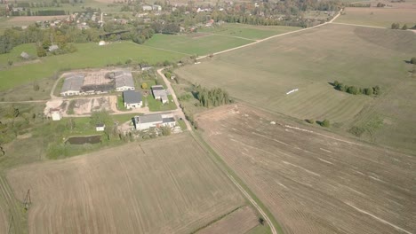 Aerial-view-of-rural-village-with-small-sawmill-and-narrow-dirt-roads