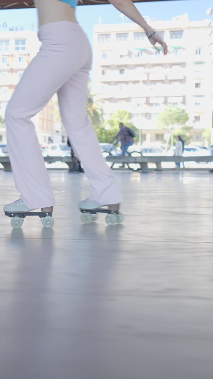 A person roller skating in wide-leg pink pants outdoors