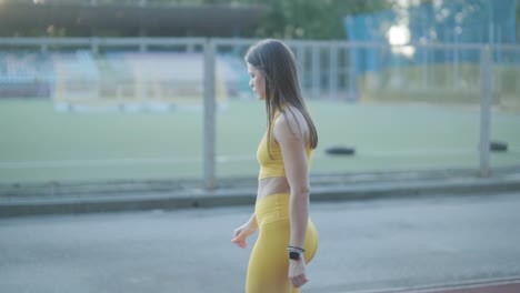 woman athlete walking on running track