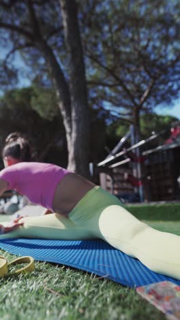 woman doing yoga splits outdoors