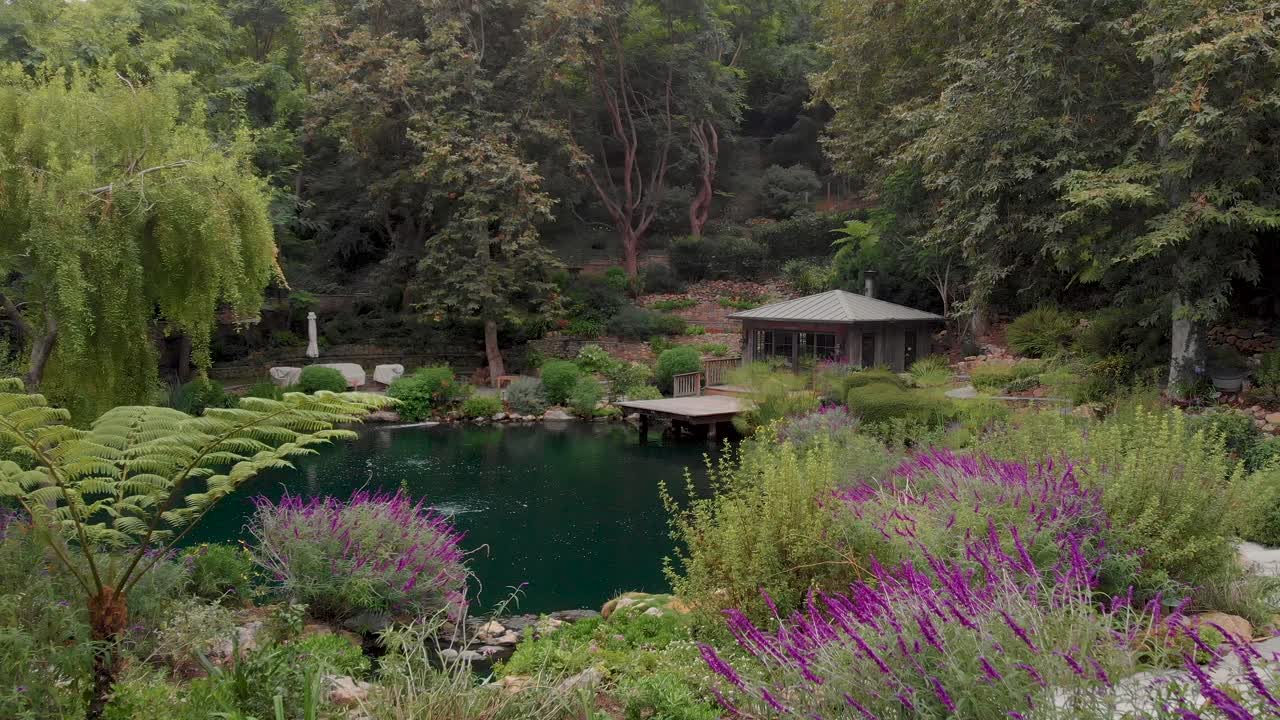 Fly through the trees and over covered path to lush ponds and botanical gardens near Malibu horse stables.