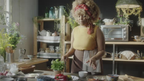 woman preparing fresh herbs in a home kitchen