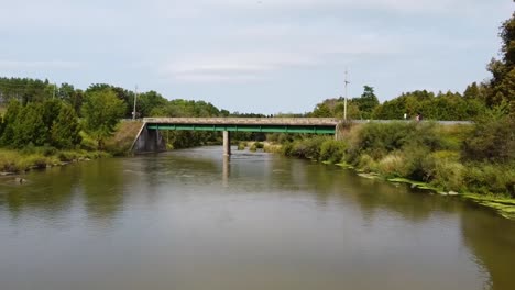 Aerial-forward-flight-over-Ontario-River-below-bridge-with-driving-Cars-during-sunny-day