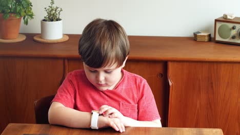 boy using smartwatch in living room 4k