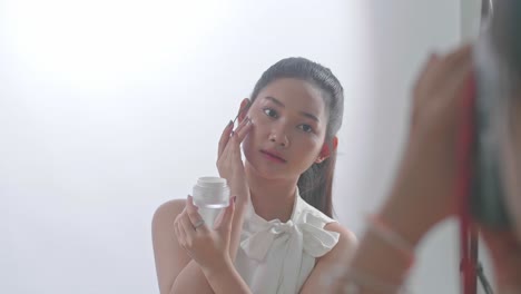 behind the scenes on photo shoot: beautiful asian model poses for a photographer, she takes photos with professional camera