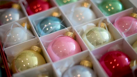 Focused-shot-of-reflective,-colorful-Christmas-balls-neatly-arranged-in-a-box