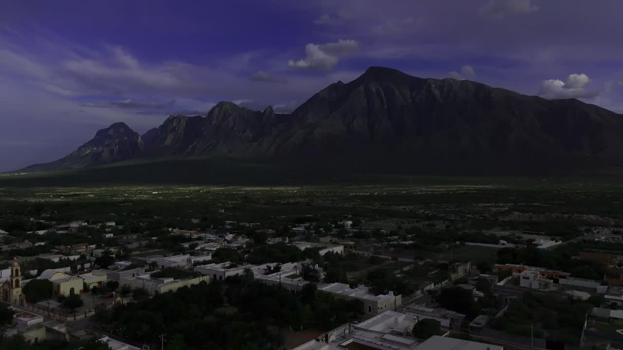 Small town in northeastern Mexico with a mountain backdrop on a warm day 4k 60fps