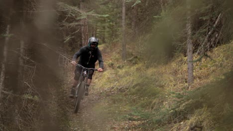 biker rides towards the camera tilt
