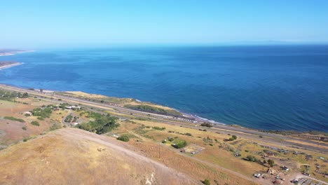 High-Aerial-View-Of-An-Amtrak-Train-Traveling-Along-The-Coast-Of-Central-California