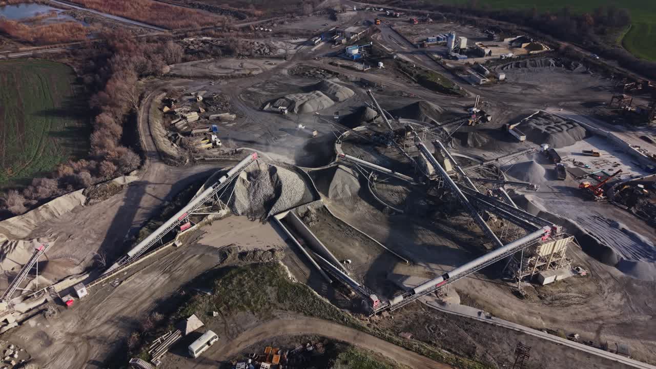 Mining happens in a quarry using machinery and conveyors