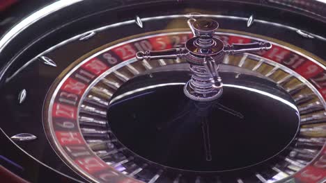 top view of european roulette in real casino spinning fast while the luck falls on the red color