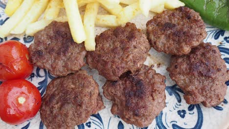 delicious turkish köfte with fries and tomatoes