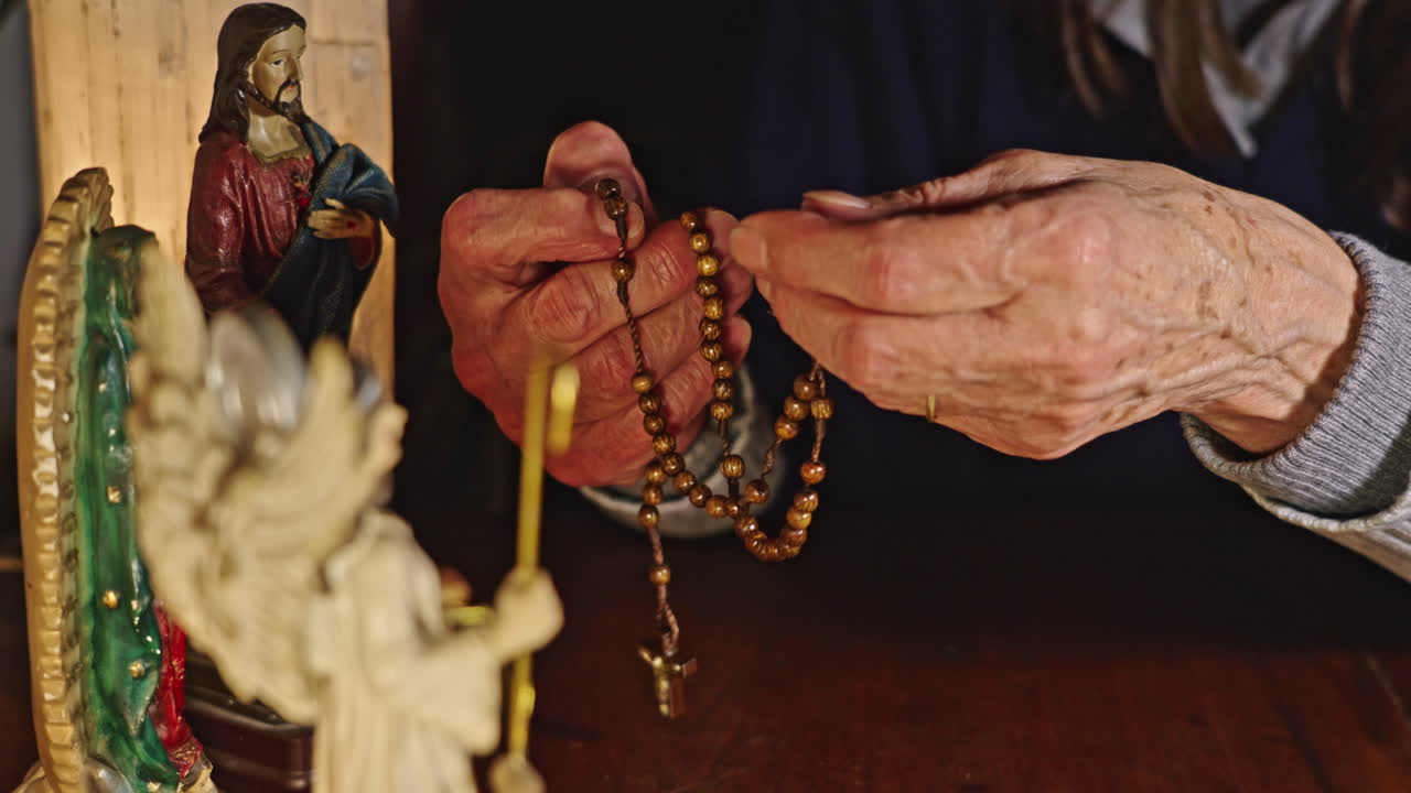 Elderly Person's Hands Holding and Praying with a Rosary