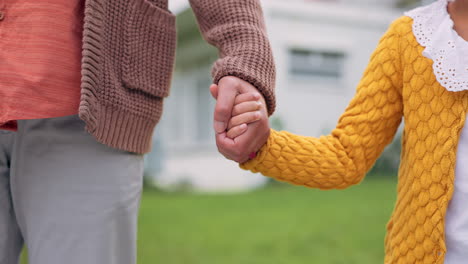 parent, child or family holding hands outdoor