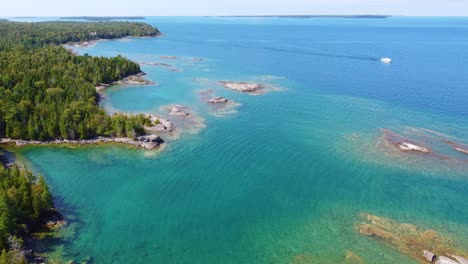 drone shot moving slowly towards the left over a dense lush boreal forest and georgian bay, ontario, canada