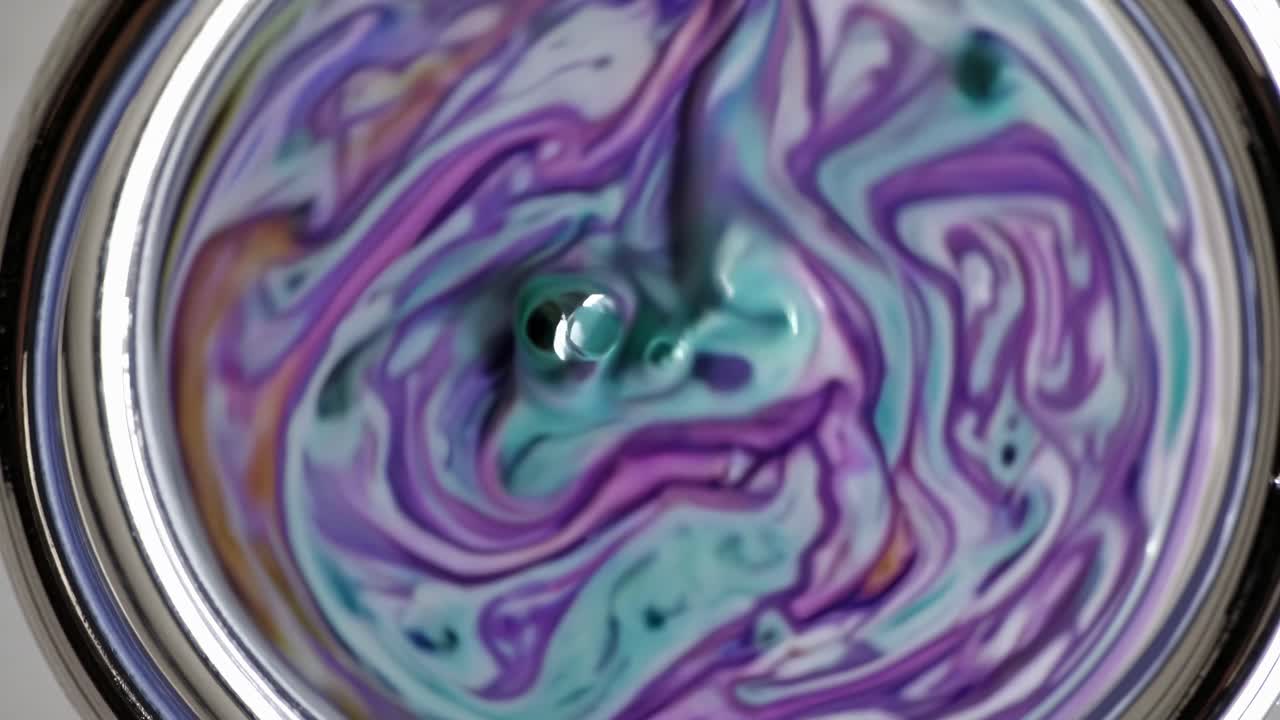 Colorful Liquid Swirls in a Metal Container