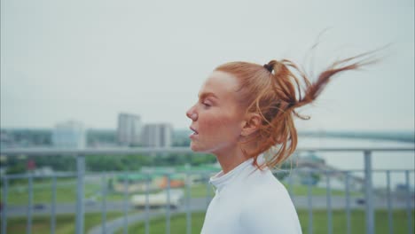 redhead woman running in the city