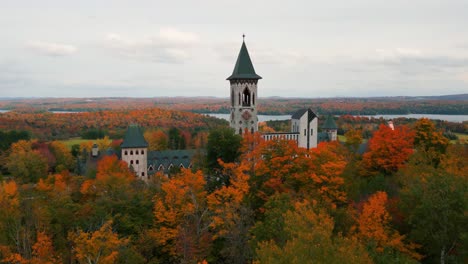 saint benoit du lac abbey in quebec province near magog on the shore of memphrémagog lake during autumn season with colorful trees, canada