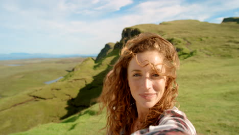 woman taking selfie in scottish highlands