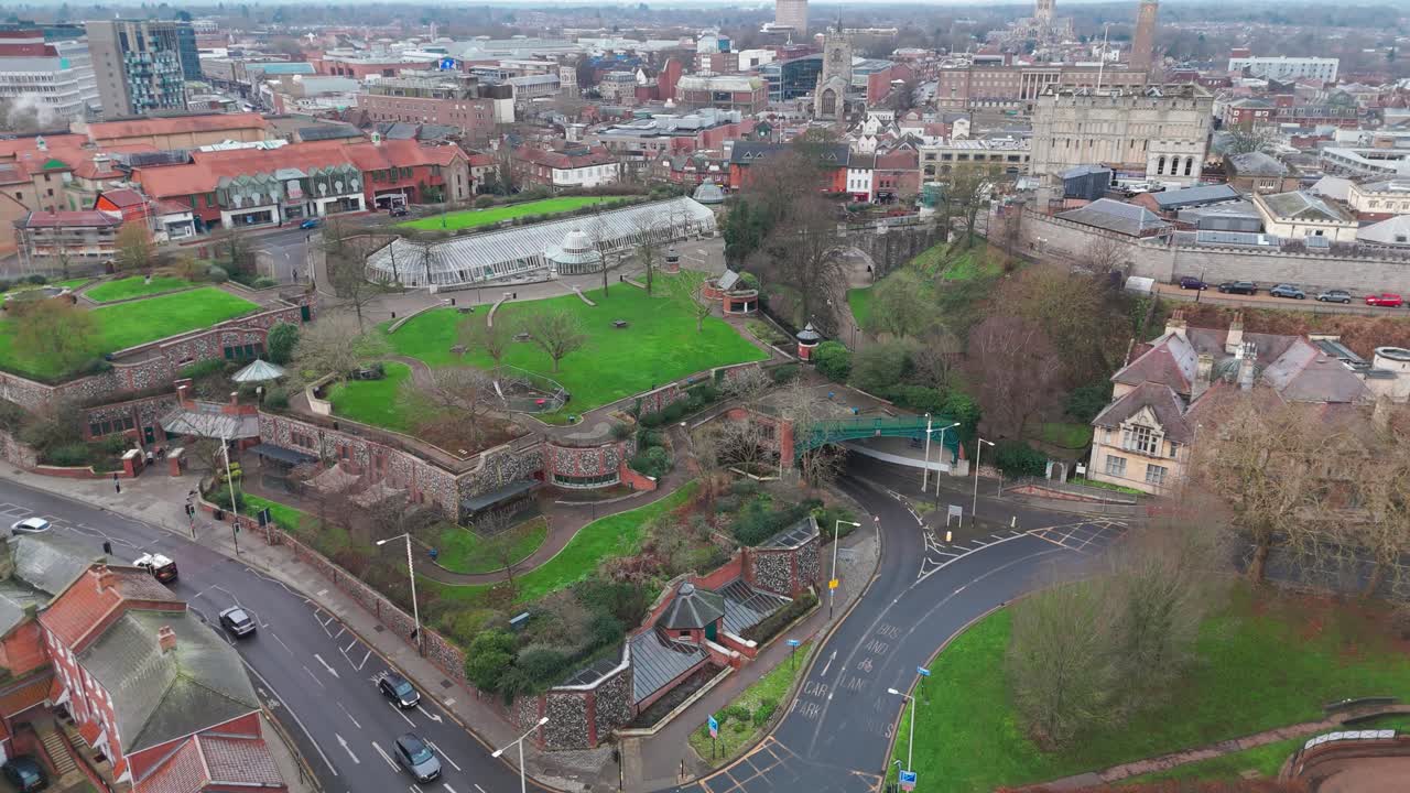 An aerial view of Norwich city center featuring churches, shops, streets, and green spaces