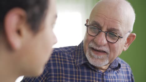 Knowledgeable-grandfather-gives-advice-to-his-grandson.