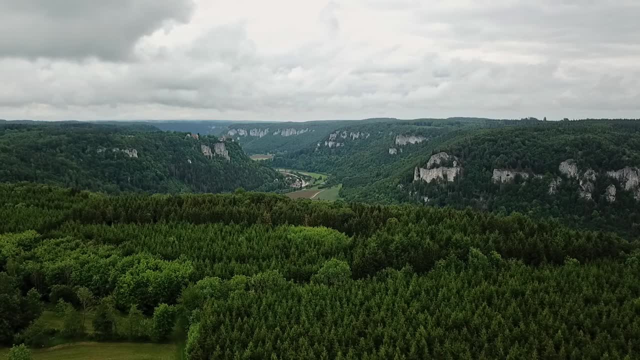 Descending over mountains with Donau valley in between, overcast sky, Eichfelsen Germany