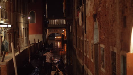 a night view of venice canal with a gondola