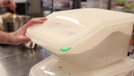 pouring flour from a container