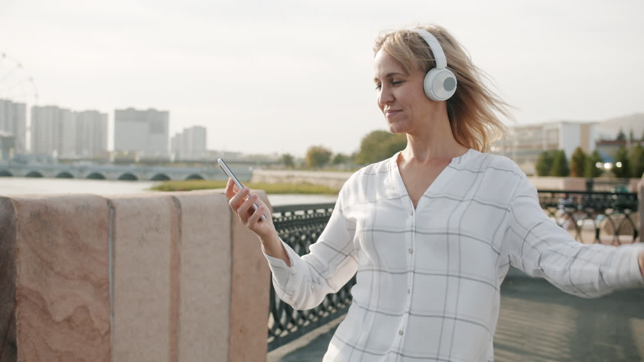 Woman Dancing to Music Outdoors
