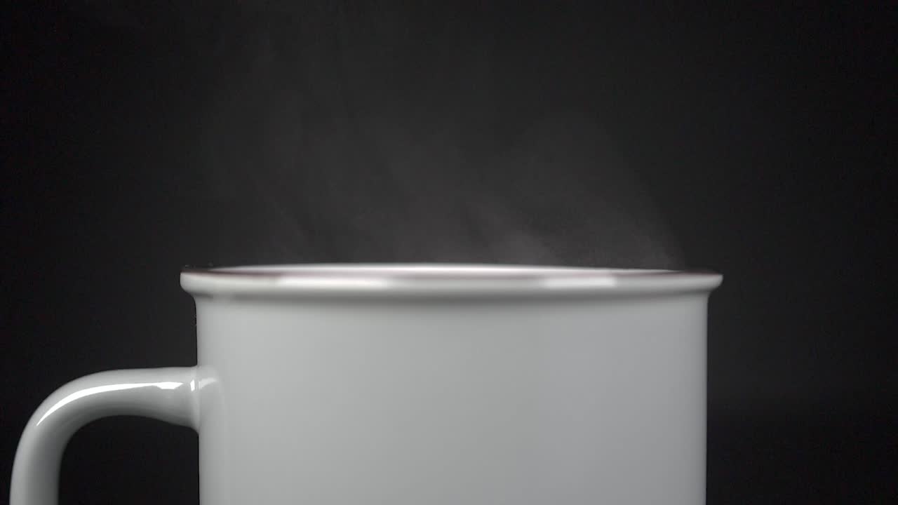Filling cup with hot water with vapour, slow motion 4K