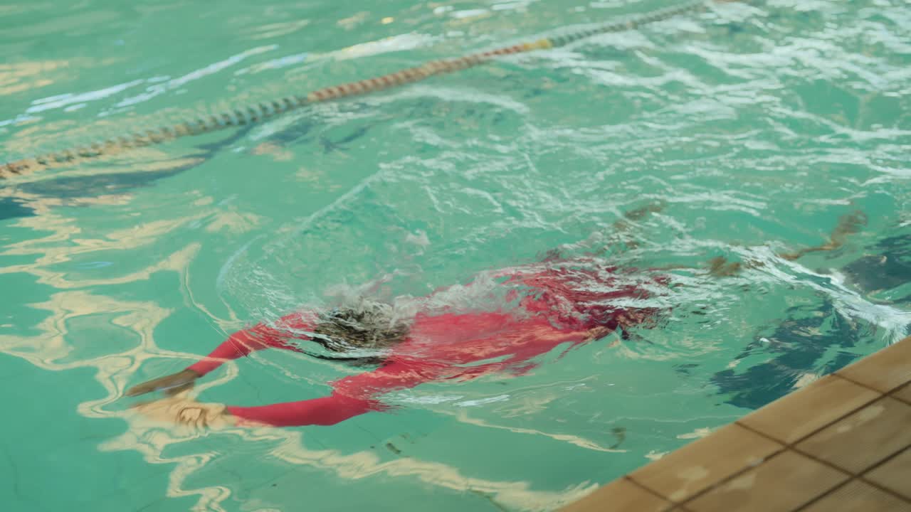 Person swimming in an indoor pool