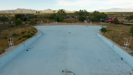 drone shot of abandoned waterpark starting over wave pool, at breakers in tucson arizona