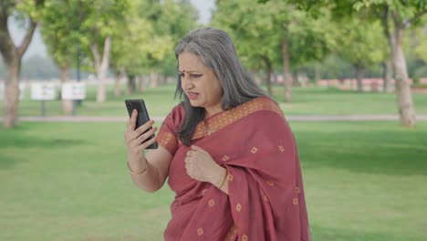 Angry-Indian-old-woman-shouting-on-video-call-in-park