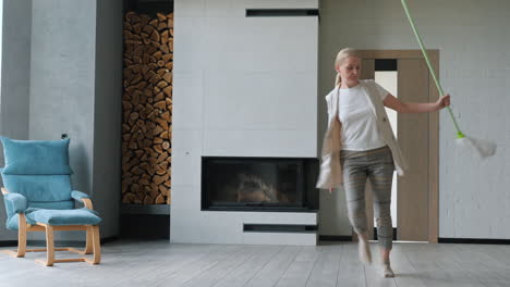 woman cleaning a modern living room with fireplace