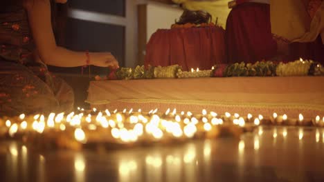 lighting diyas at home. celebrating indian festival.