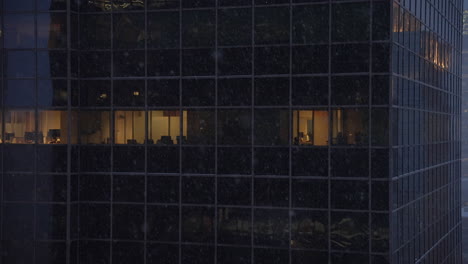 close up establishing shot of urban high-rise office building windows during a snow storm