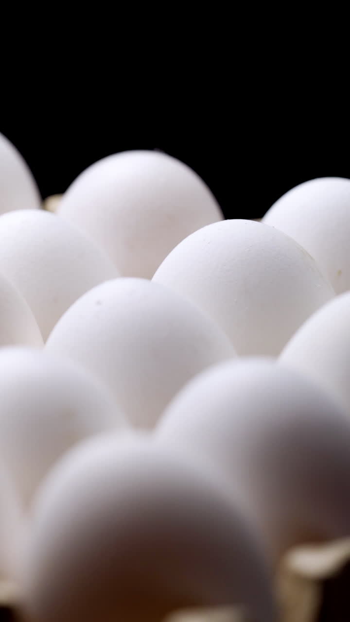 White chicken eggs. Chicken eggs in the container Vertical video