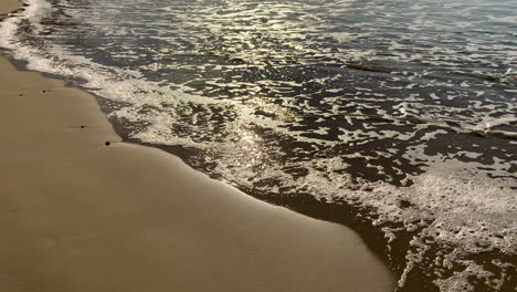 walking along the oregon coast surf on ecola beach slowly panning up to reveal the coast