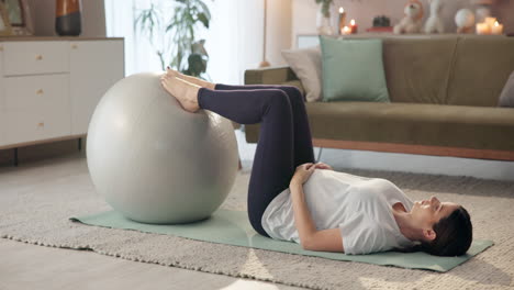 woman exercising with exercise ball at home