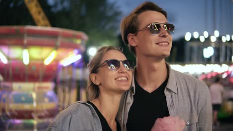 Portrait-Of-A-Young,-Cheerful-Hipster-Couple-In-Sunglasses-Are-Looking-At-Attractions-Light