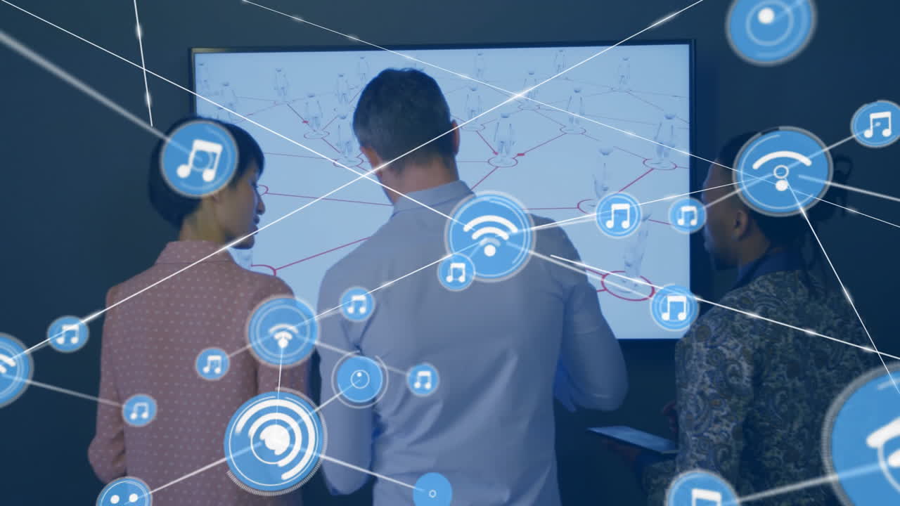 Three professionals analyzing network in office, holding tablet and showing floating digital icons