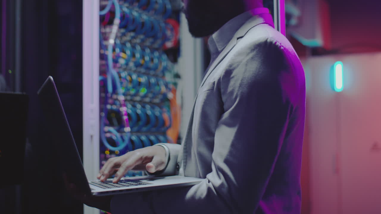 Data Center Engineer Working on Laptop