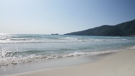 Wave-crashing-onto-yellow-sand-beach-on-Thasos-island,-Greece