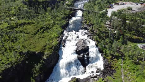 flying towards the huge waterfall of voringfossen in norway