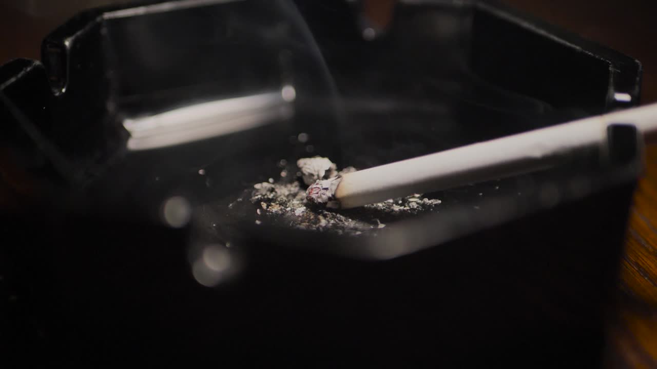 Close up smoking cigarette on man hand. Slowmotion. Scene G