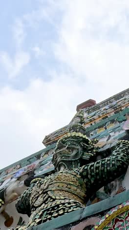 detailed view of ornate statues at wat arun temple, bangkok